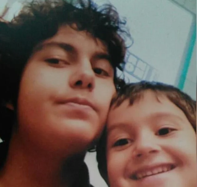 F. Emre Bora with a child in a personal photograph